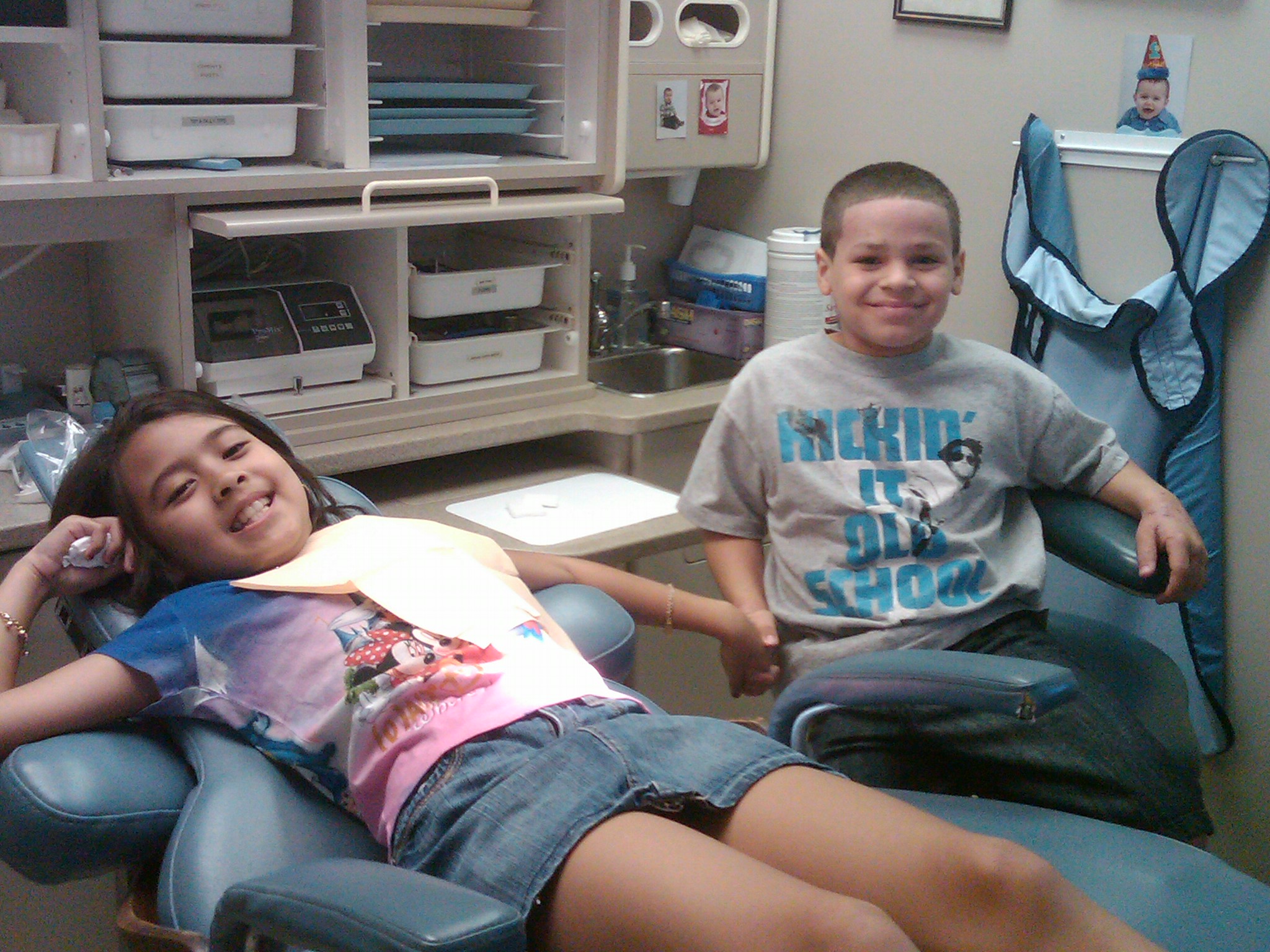 Khiana & her friend Eric holding her hand to help her through her appointment